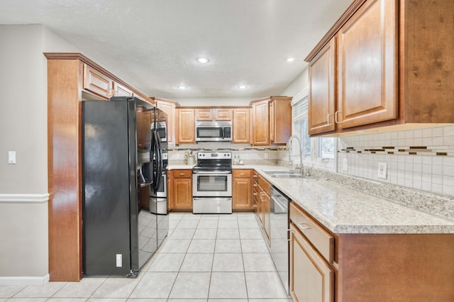 3477 W Broadmoor Ct, Springfield, MO 65807 - kitchen with appliances with stainless steel finishes, tasteful backsplash, light countertops, light tile patterned flooring, and recessed lighting