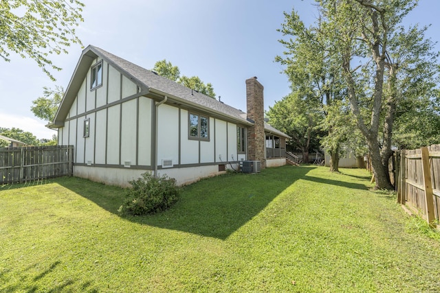 3477 W Broadmoor Ct, Springfield, MO 65807 - rear view of house with board and batten siding, a chimney, and a fenced backyard
