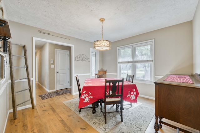 3477 W Broadmoor Ct, Springfield, MO 65807 - dining room with a textured ceiling and light wood-type flooring