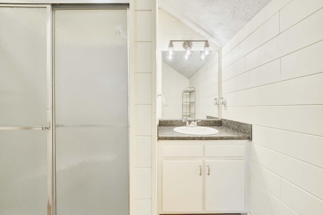 3477 W Broadmoor Ct, Springfield, MO 65807 - bathroom with vaulted ceiling, a shower stall, and vanity