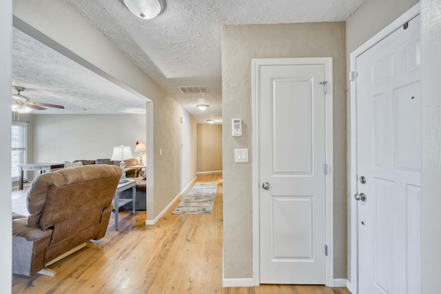 3477 W Broadmoor Ct, Springfield, MO 65807 - hall with light wood-style flooring and a textured ceiling