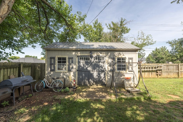 3477 W Broadmoor Ct, Springfield, MO 65807 - back of house featuring a fenced backyard, a storage shed, and a metal roof