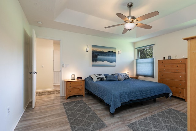 360 Durango Ln, Billings, MO 65610 - bedroom featuring a tray ceiling, light wood-style floors, and a ceiling fan