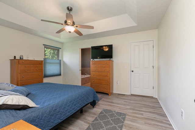 360 Durango Ln, Billings, MO 65610 - bedroom with a tray ceiling, light wood-type flooring, ensuite bathroom, and ceiling fan