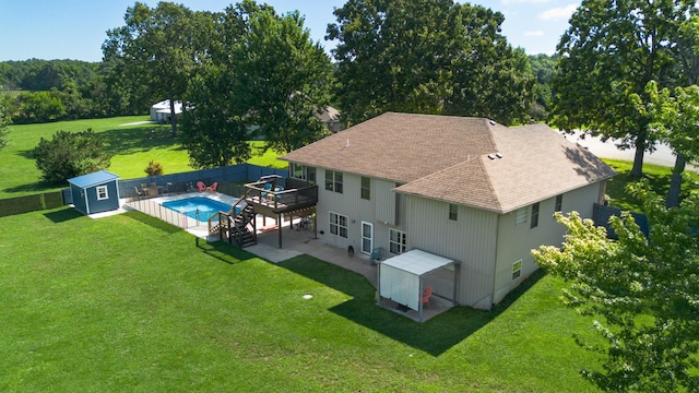 360 Durango Ln, Billings, MO 65610 - rear view of property with a shingled roof, a shed, a wooden deck, a lawn, and a patio area