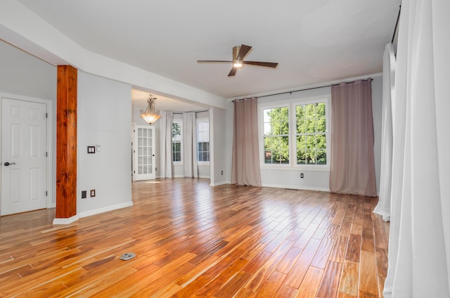 4225 E Crosswinds Pl, Springfield, MO 65809 - unfurnished room with a ceiling fan, light wood-type flooring, and a chandelier