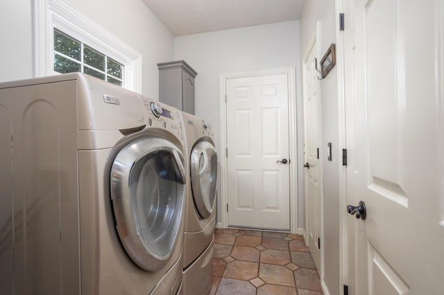 4225 E Crosswinds Pl, Springfield, MO 65809 - laundry room featuring washer and clothes dryer, cabinet space, and light tile patterned floors
