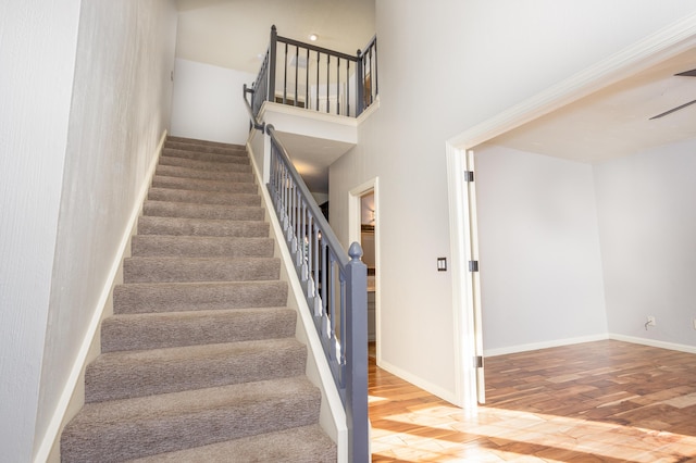 4225 E Crosswinds Pl, Springfield, MO 65809 - staircase with a towering ceiling and wood finished floors