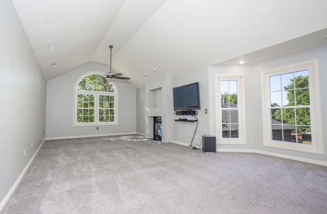 4225 E Crosswinds Pl, Springfield, MO 65809 - unfurnished living room featuring carpet flooring, a ceiling fan, lofted ceiling, and a glass covered fireplace