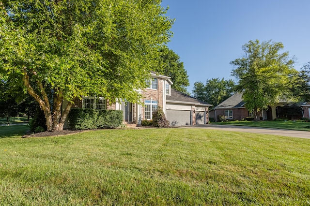 4225 E Crosswinds Pl, Springfield, MO 65809 - view of front of house featuring driveway, an attached garage, a front lawn, and brick siding