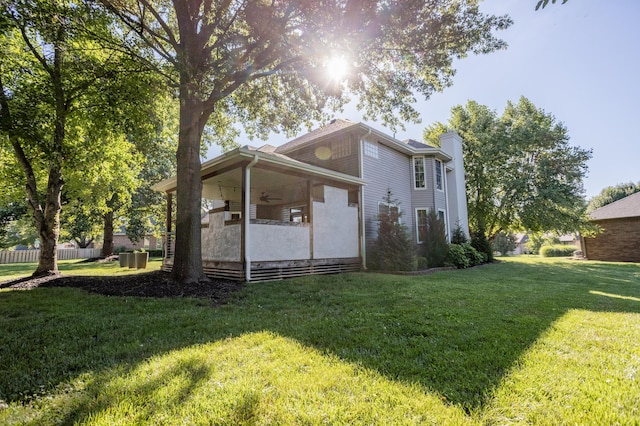 4225 E Crosswinds Pl, Springfield, MO 65809 - view of property exterior featuring ceiling fan, a yard, and a chimney