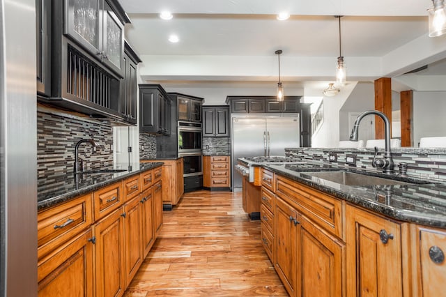 4225 E Crosswinds Pl, Springfield, MO 65809 - kitchen featuring light wood-style flooring, stainless steel appliances, decorative backsplash, glass insert cabinets, and recessed lighting