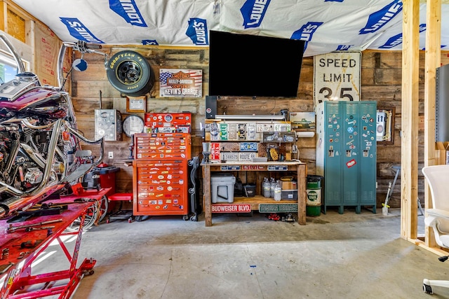 208 E Washington St, Pierce City, MO 65723 - garage featuring a workshop area and wooden walls