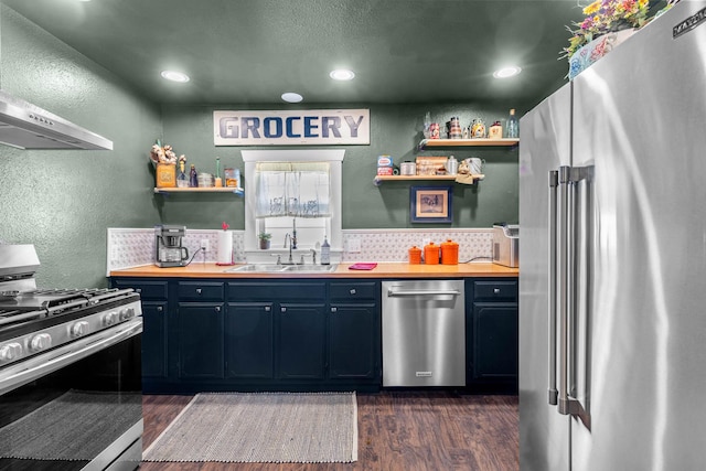 208 E Washington St, Pierce City, MO 65723 - kitchen with appliances with stainless steel finishes, open shelves, dark wood-style floors, wooden counters, and a textured wall