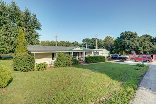 1410 S Elizabeth Rd, Stockton, MO 65785 - ranch-style house with a porch, a front yard, and a metal roof