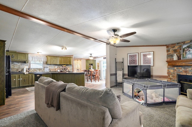 1410 S Elizabeth Rd, Stockton, MO 65785 - living area with a ceiling fan, a fireplace, wood finished floors, and beam ceiling