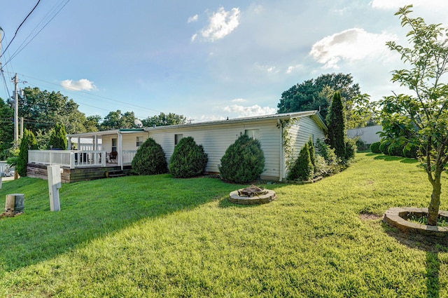 1410 S Elizabeth Rd, Stockton, MO 65785 - view of front of house with a fire pit, a front yard, and a deck