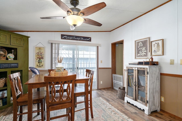 1410 S Elizabeth Rd, Stockton, MO 65785 - dining area featuring crown molding, light wood-style floors, a ceiling fan, and vaulted ceiling
