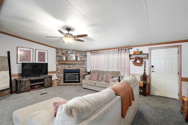 1410 S Elizabeth Rd, Stockton, MO 65785 - carpeted living area featuring crown molding, a ceiling fan, a stone fireplace, vaulted ceiling, and a textured ceiling