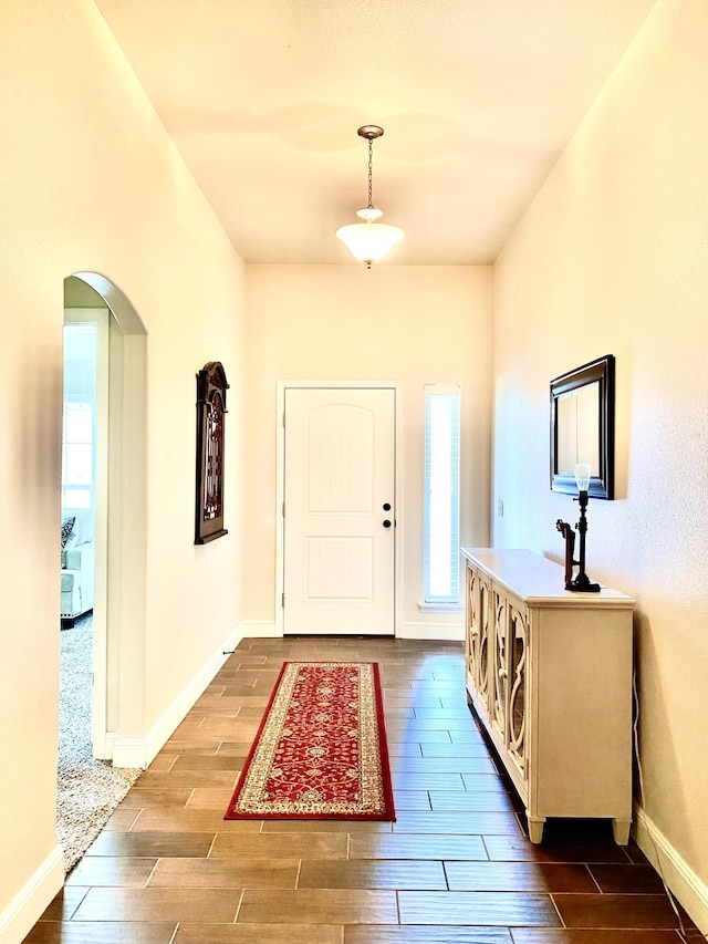 1113 Chesterfield Dr, Webb City, MO 64870 - foyer featuring arched walkways and dark wood finished floors
