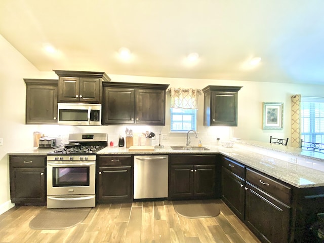1113 Chesterfield Dr, Webb City, MO 64870 - kitchen with stainless steel appliances, light wood finished floors, a peninsula, light stone countertops, and recessed lighting