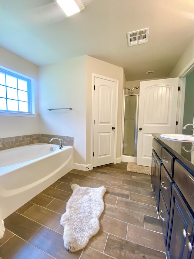 1113 Chesterfield Dr, Webb City, MO 64870 - full bath with a garden tub, wood finish floors, double vanity, and a stall shower