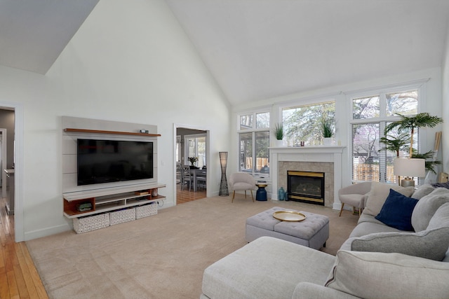3931 E Stanford St, Springfield, MO 65809 - living room featuring high vaulted ceiling, a fireplace with flush hearth, plenty of natural light, and wood finished floors
