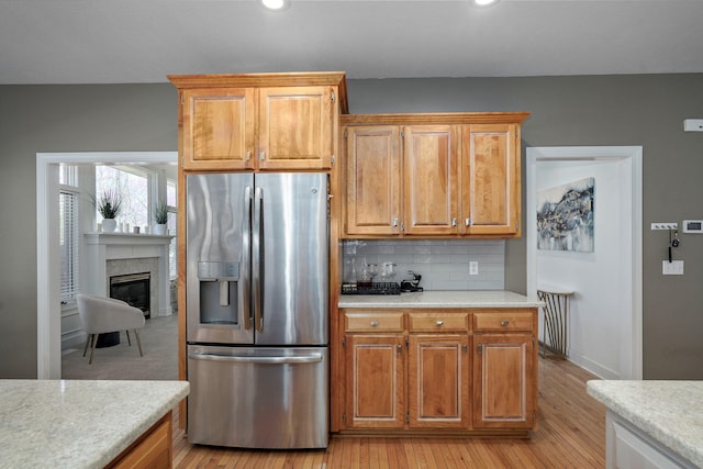 3931 E Stanford St, Springfield, MO 65809 - kitchen with stainless steel refrigerator with ice dispenser, light countertops, light wood-style floors, tasteful backsplash, and recessed lighting