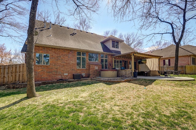 3931 E Stanford St, Springfield, MO 65809 - rear view of property with a jacuzzi, a patio, a fenced backyard, brick siding, and a pergola