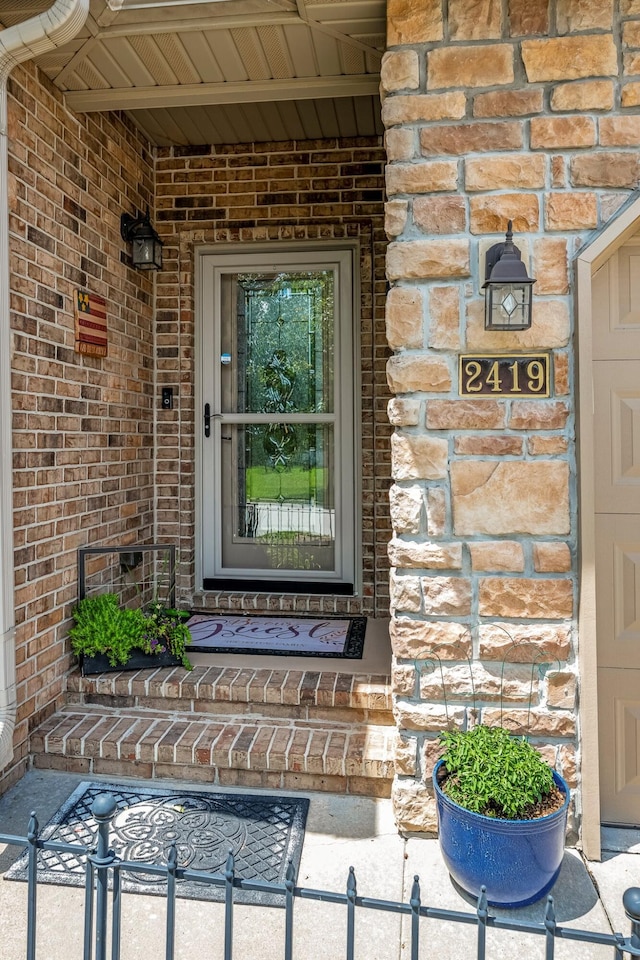 2419 W Deerbrooke Trl, Ozark, MO 65721 - doorway to property featuring brick siding and a porch