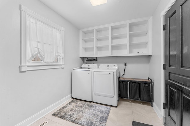2311 S Golden Ave, Springfield, MO 65807 - laundry area featuring washing machine and clothes dryer and light tile patterned floors