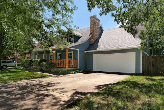 2311 S Golden Ave, Springfield, MO 65807 - view of front of house featuring a porch, an attached garage, concrete driveway, a chimney, and a shingled roof