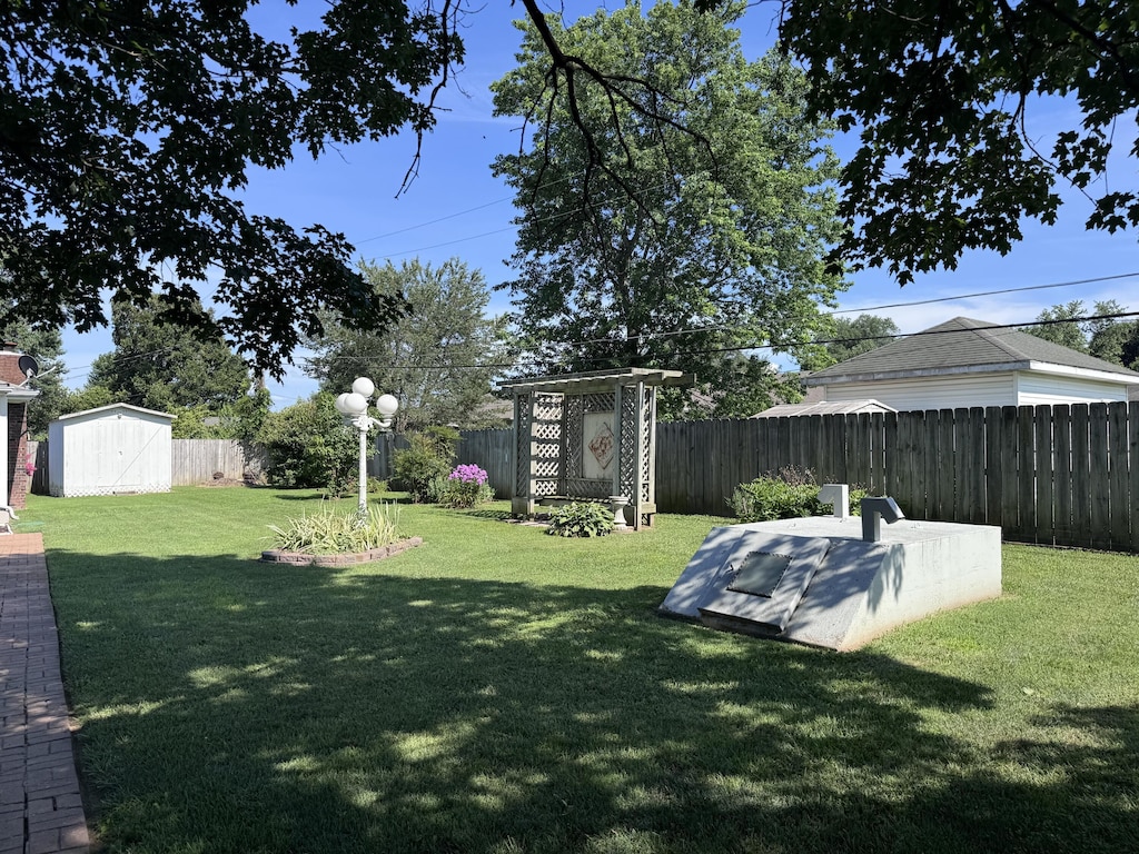 104 E Meadowbrook Ave, Clever, MO 65631 - fenced backyard featuring a storage shed