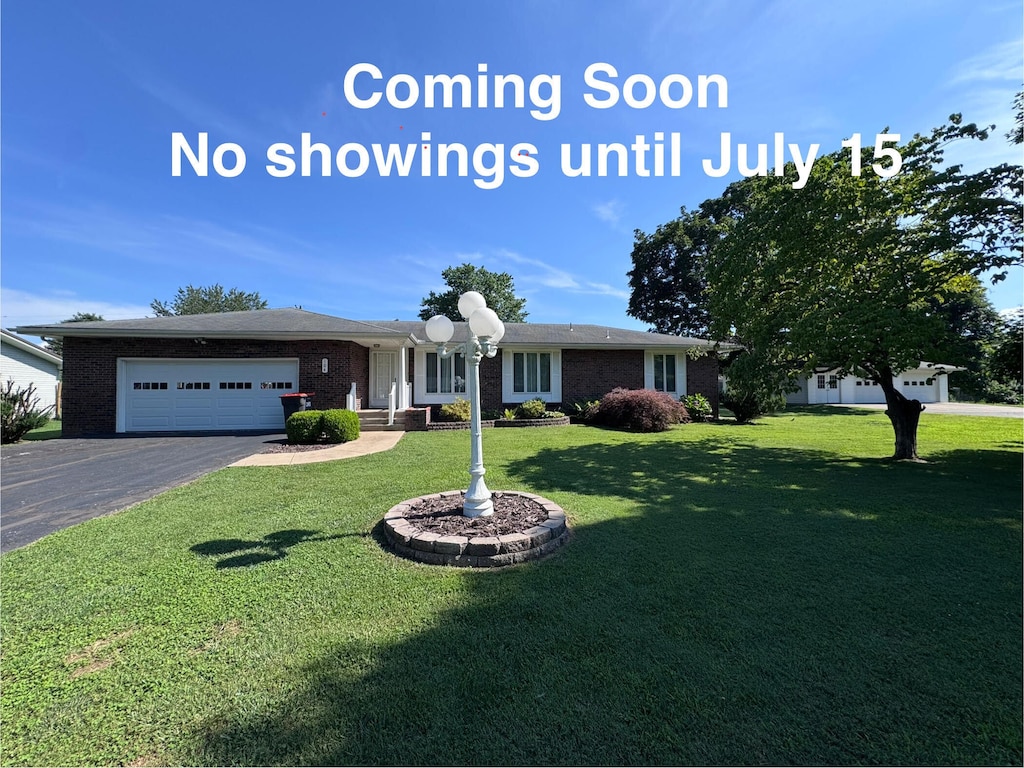 104 E Meadowbrook Ave, Clever, MO 65631 - ranch-style house with driveway, an attached garage, a front yard, and brick siding