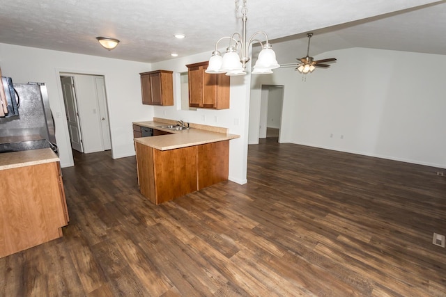 297 Kelsi Ln, Branson, MO 65616 - kitchen with a peninsula, brown cabinets, dark wood-style flooring, light countertops, and a ceiling fan