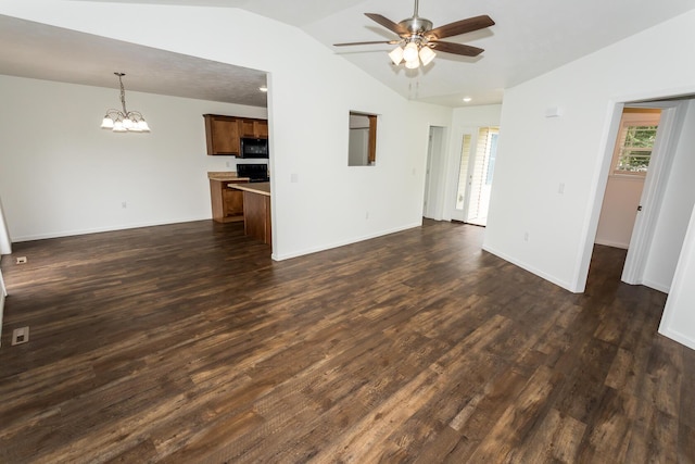 297 Kelsi Ln, Branson, MO 65616 - unfurnished living room featuring vaulted ceiling, a chandelier, ceiling fan, and dark wood-style floors