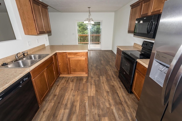 297 Kelsi Ln, Branson, MO 65616 - kitchen with black appliances, dark wood-style flooring, a peninsula, a chandelier, and light countertops