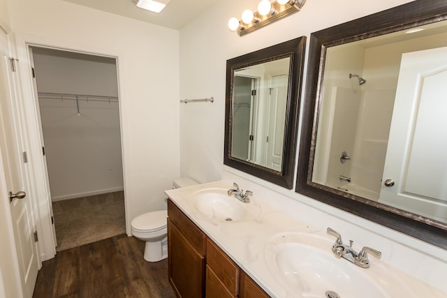 297 Kelsi Ln, Branson, MO 65616 - full bath with wood finished floors, double vanity, a spacious closet, and shower / washtub combination