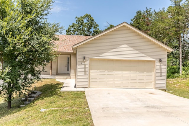 297 Kelsi Ln, Branson, MO 65616 - ranch-style house featuring concrete driveway, an attached garage, a shingled roof, and a front lawn