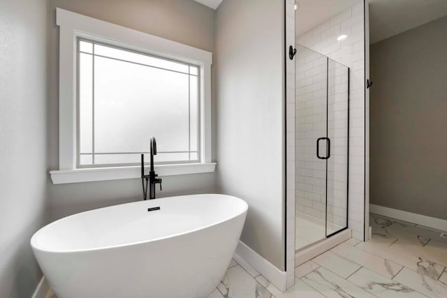 4212 Tuscany Cir, Ozark, MO 65721 - full bath featuring marble look tiles, plenty of natural light, a freestanding tub, and a stall shower