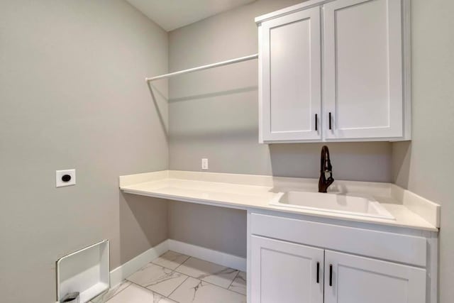 4212 Tuscany Cir, Ozark, MO 65721 - laundry area featuring hookup for an electric dryer, cabinet space, and light marble finish flooring