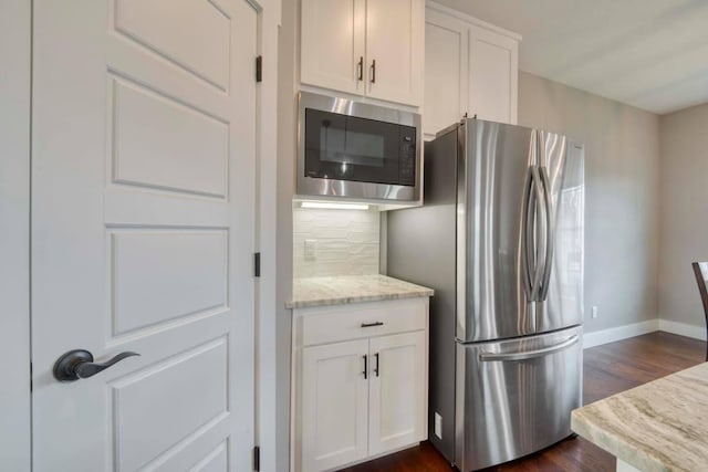 4212 Tuscany Cir, Ozark, MO 65721 - kitchen featuring stainless steel appliances, backsplash, dark wood-style flooring, and white cabinetry