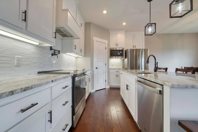 4212 Tuscany Cir, Ozark, MO 65721 - kitchen with appliances with stainless steel finishes, recessed lighting, light stone counters, dark wood-style flooring, and white cabinets