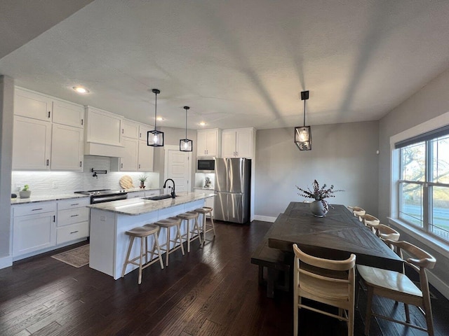 4212 Tuscany Cir, Ozark, MO 65721 - kitchen featuring stainless steel appliances, recessed lighting, white cabinets, dark wood-type flooring, and decorative backsplash