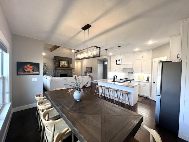 4212 Tuscany Cir, Ozark, MO 65721 - dining space featuring dark wood-style floors, a stone fireplace, and recessed lighting