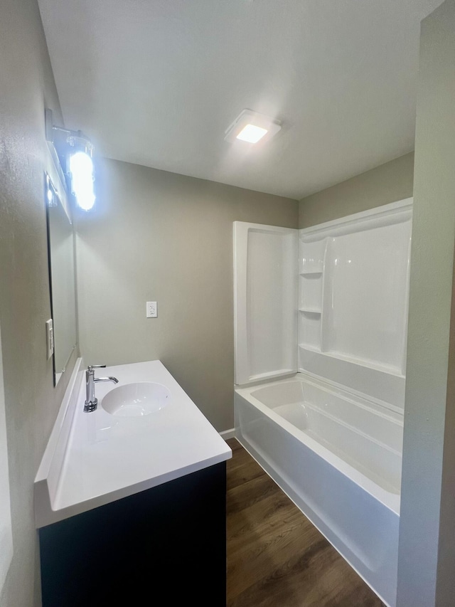 711 W Woodbine Rd, Ash Grove, MO 65604 - full bathroom featuring vanity, wood finished floors, and shower / washtub combination