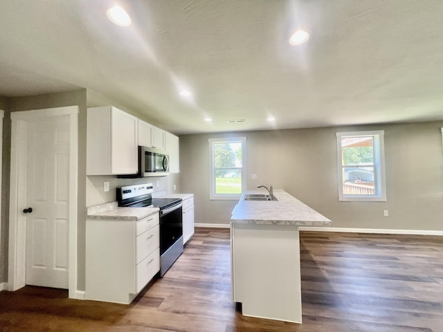 711 W Woodbine Rd, Ash Grove, MO 65604 - kitchen featuring appliances with stainless steel finishes, light countertops, recessed lighting, white cabinetry, and dark wood-style flooring