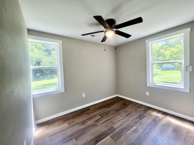 711 W Woodbine Rd, Ash Grove, MO 65604 - unfurnished room featuring dark wood finished floors and a ceiling fan