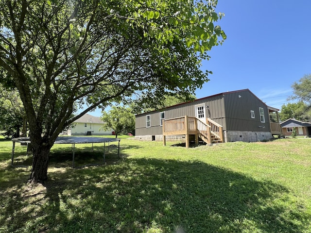 711 W Woodbine Rd, Ash Grove, MO 65604 - back of house featuring a trampoline, a yard, a deck, and crawl space