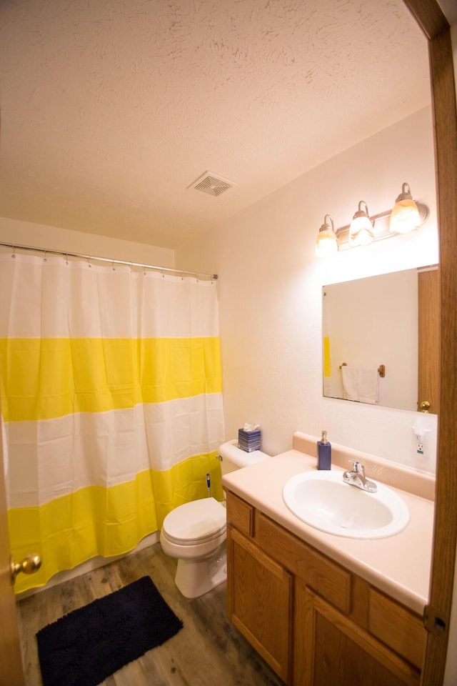 602 E Robertson, Ozark, MO 65721 - full bath featuring vanity, wood finished floors, a textured ceiling, and a shower with curtain